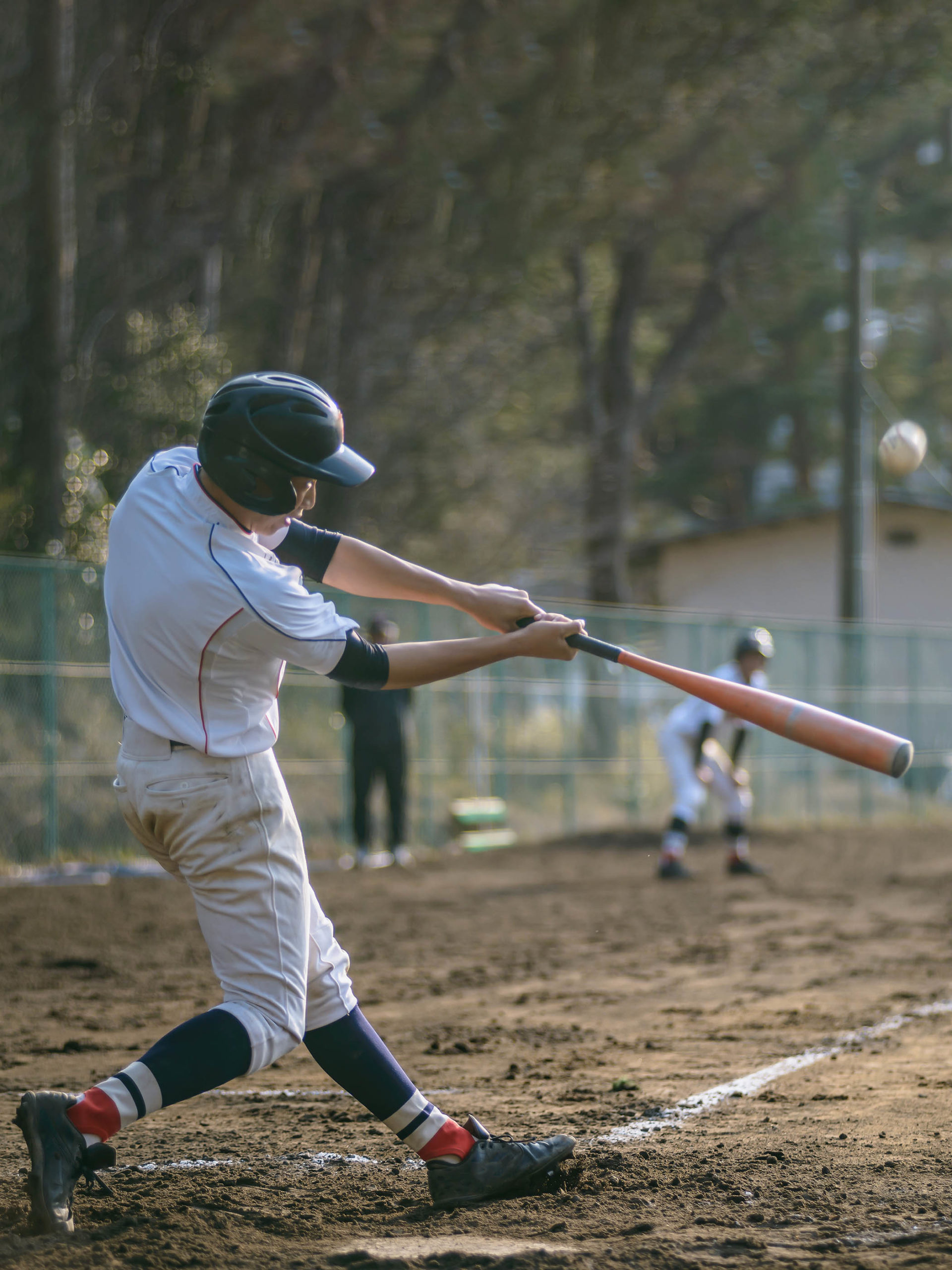 High School Baseball player hitting a home run