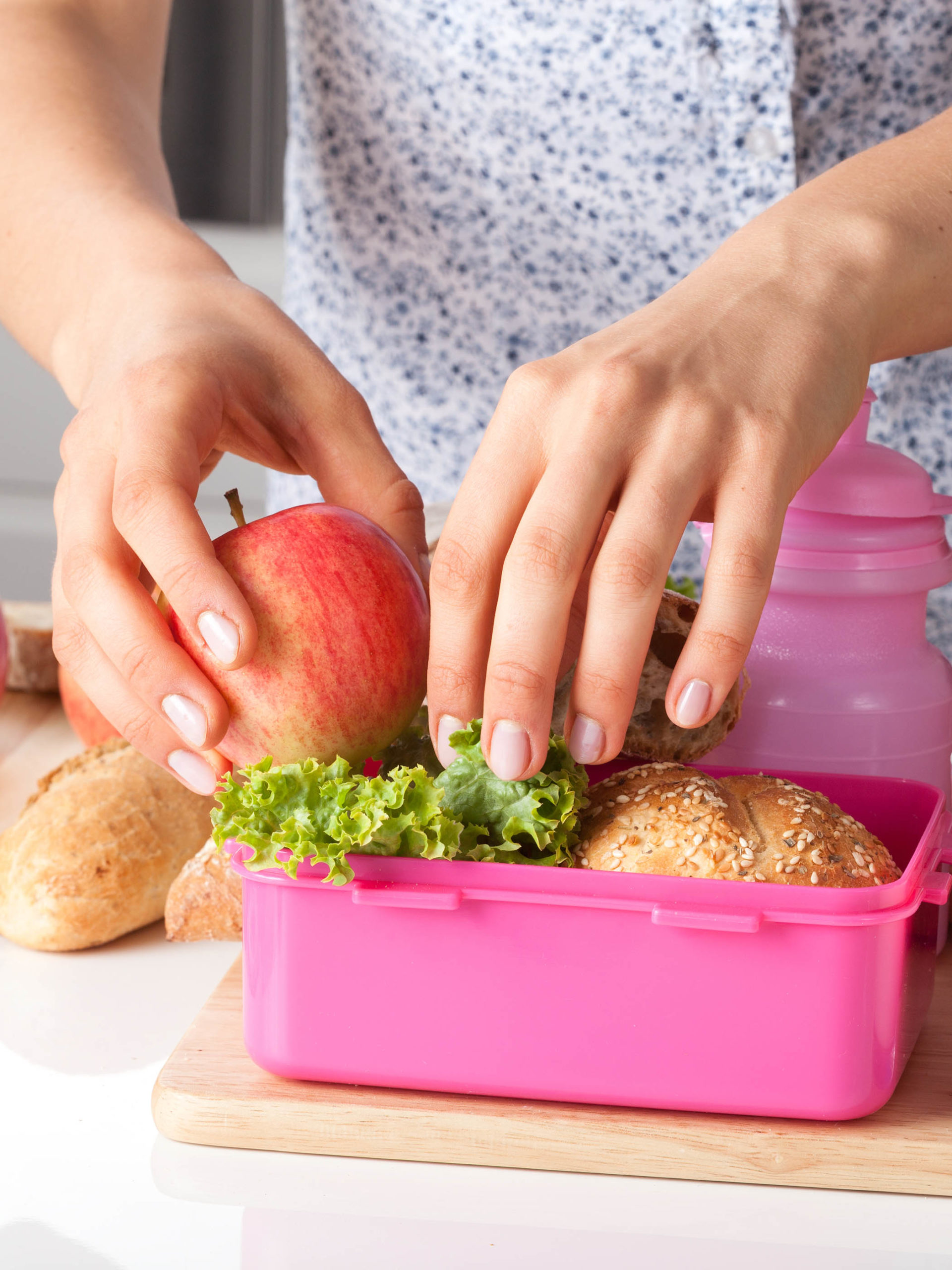 Young woman making school lunch in the morning