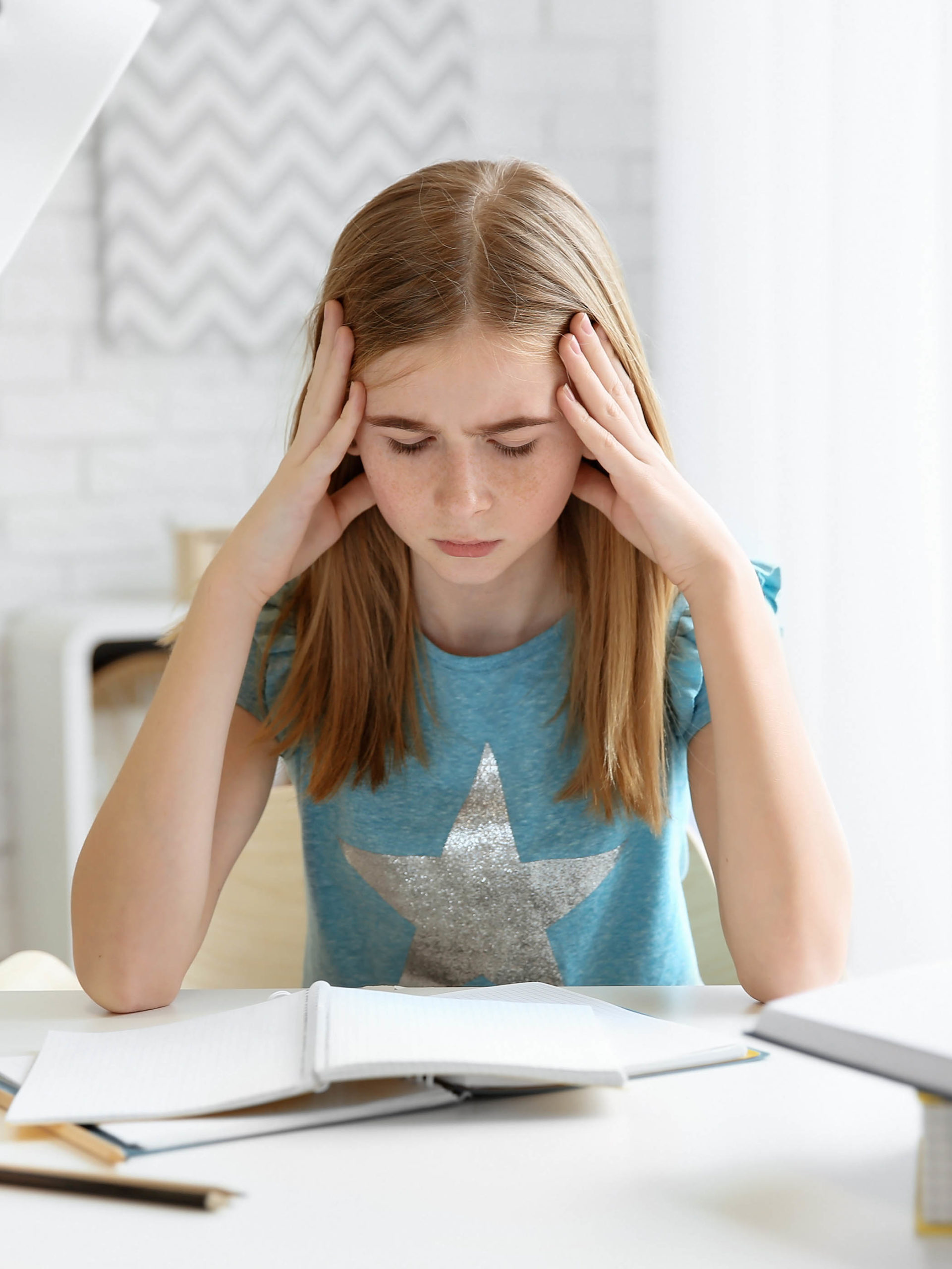 Teenage girl suffering from headache