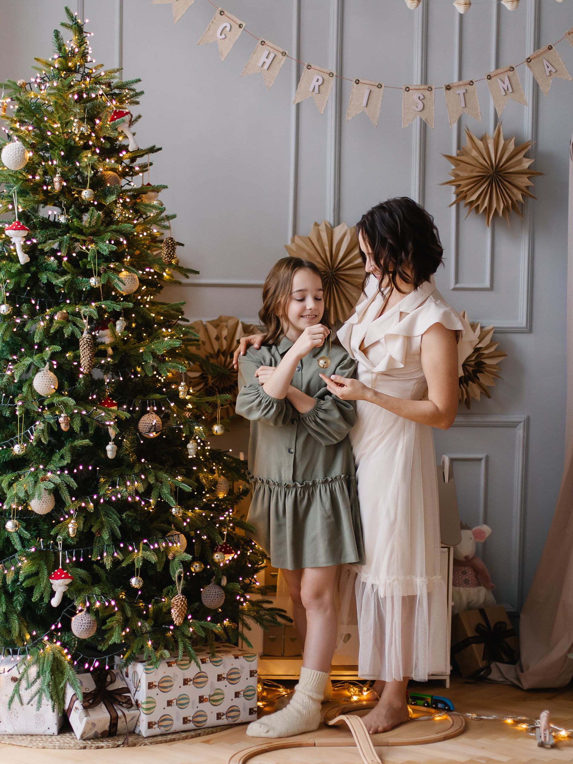 Mother and daughter decorate the Christmas tree together