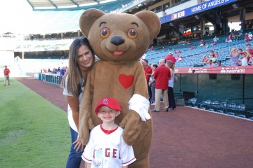 Cyrus, with Dr. Michele Domico, medical director of CHOC CVICU and Choco, at a CHOC Night at Angels Stadium event. 