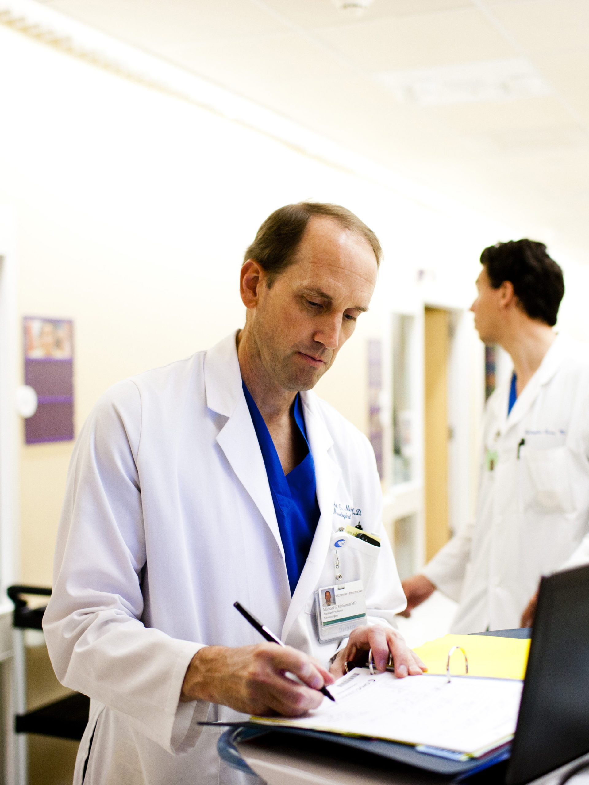 Dr. Michael Muhonen, medical director of the CHOC Neuroscience Institute, writing notes in patient chart
