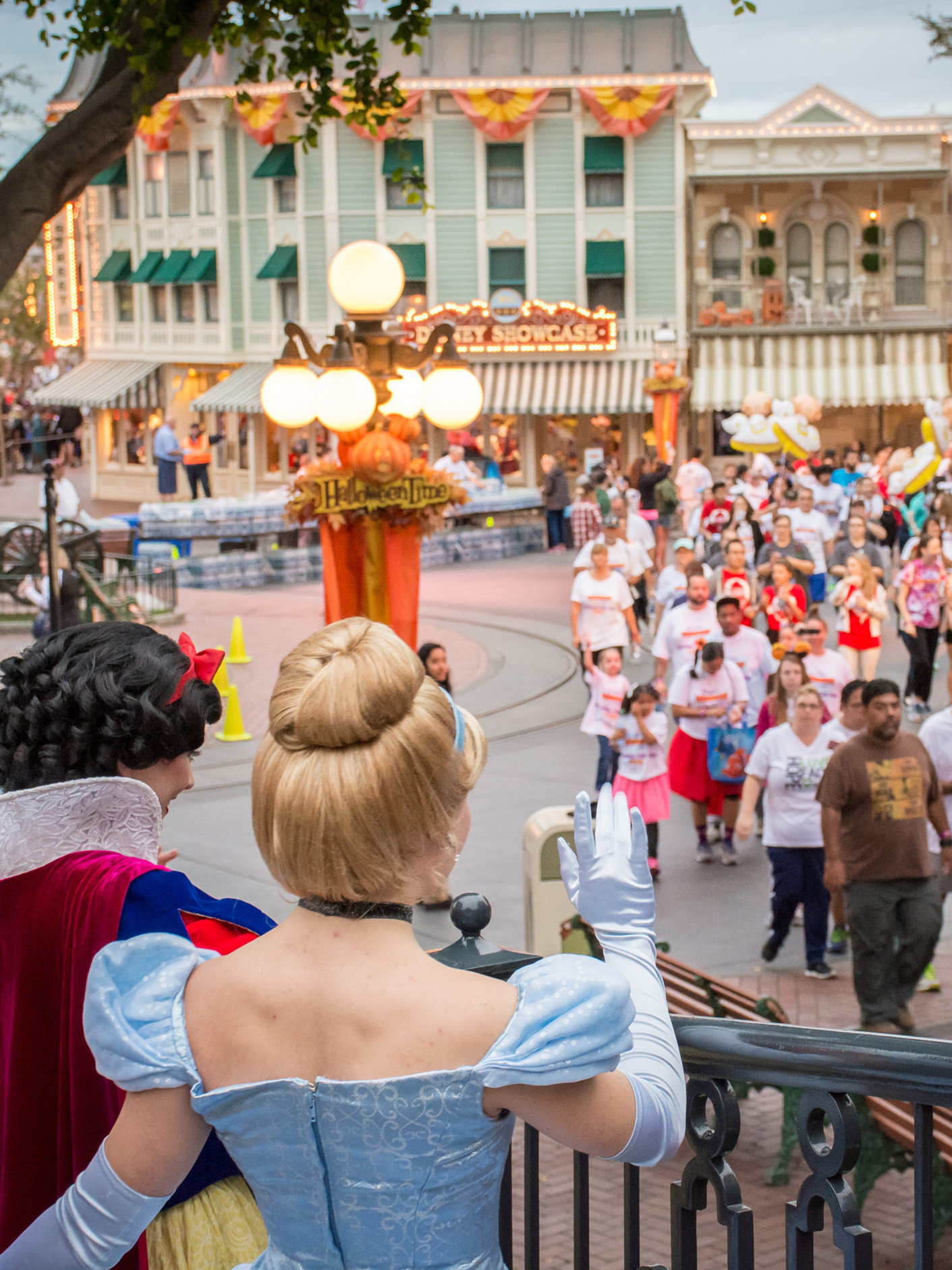 Disney princesses waving to crowd participating in CHOC walk in Disneyland