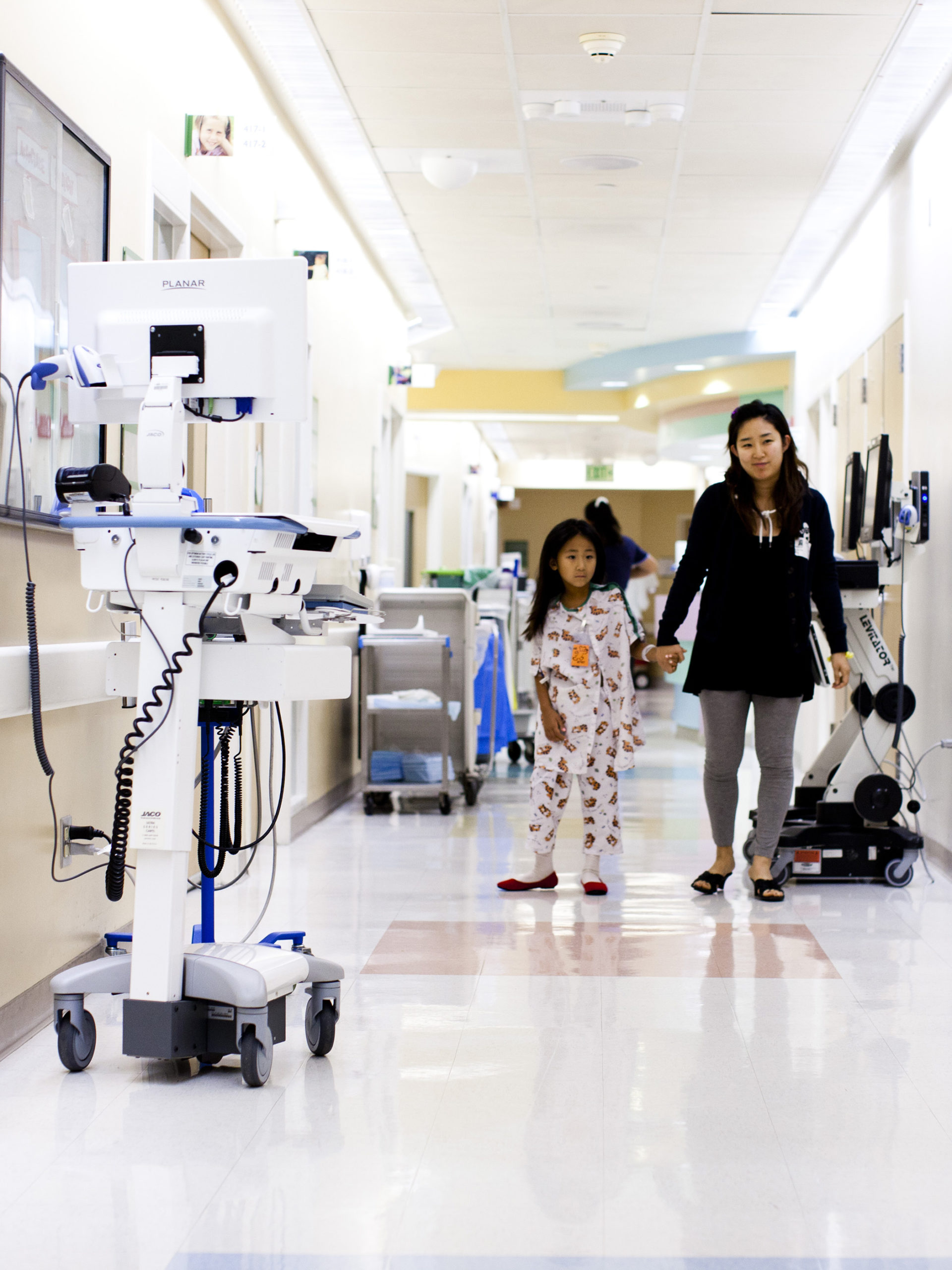 CHOC patient and mom walking through hallways at CHOC hospital