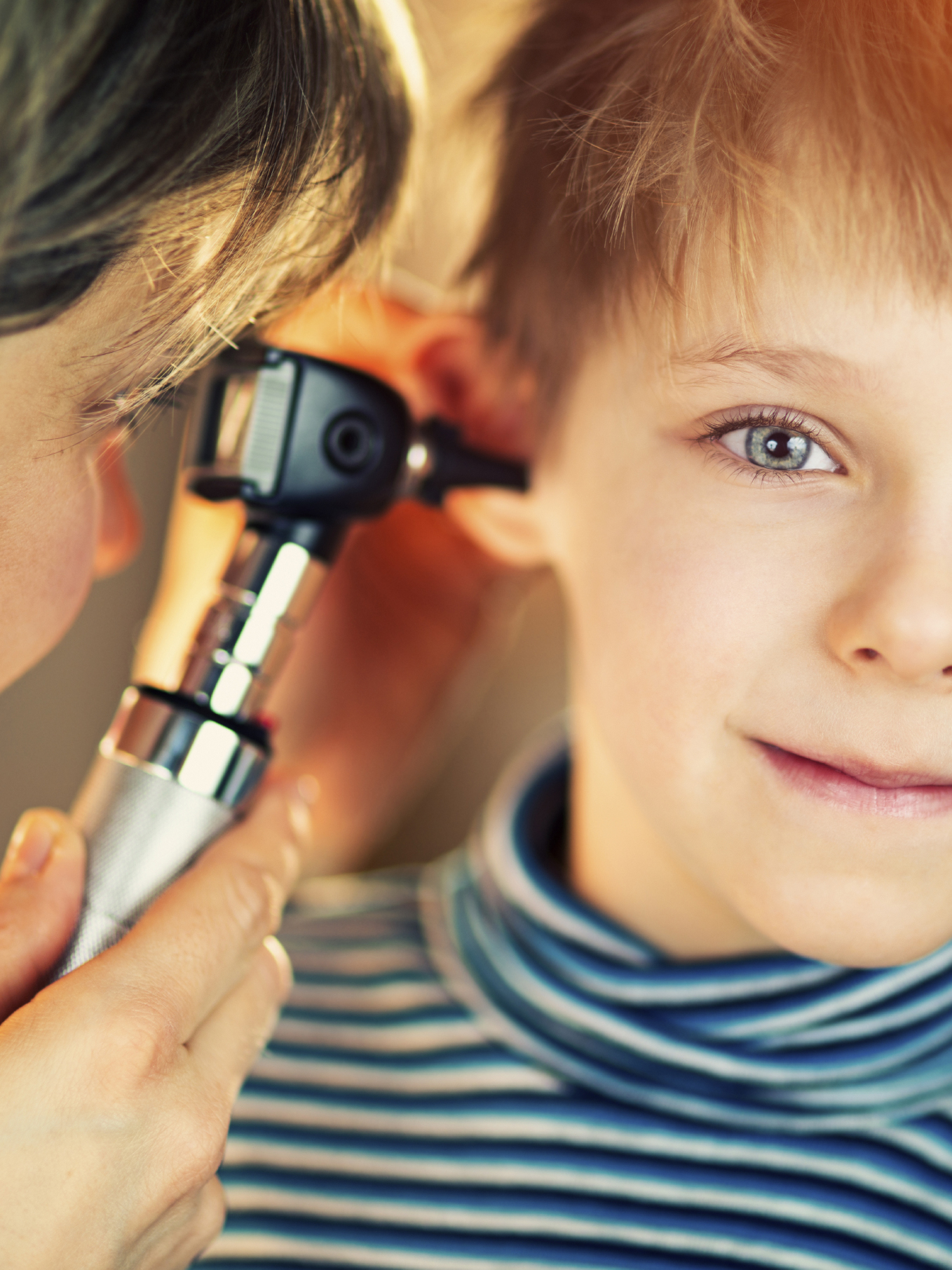 young boy getting his ear examined by ear nose and throat doctor