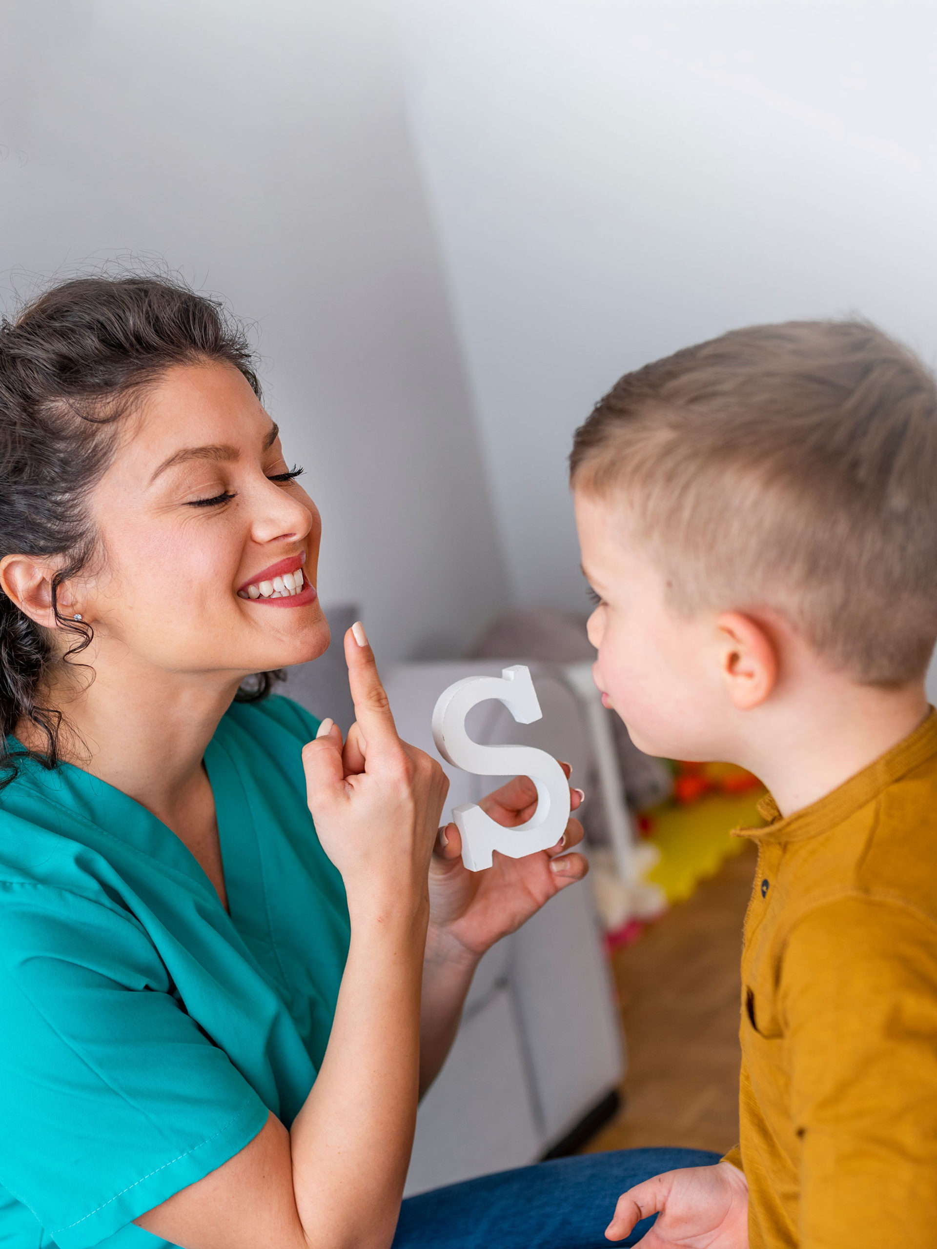 Speech therapist teaches young boy to say the letter S