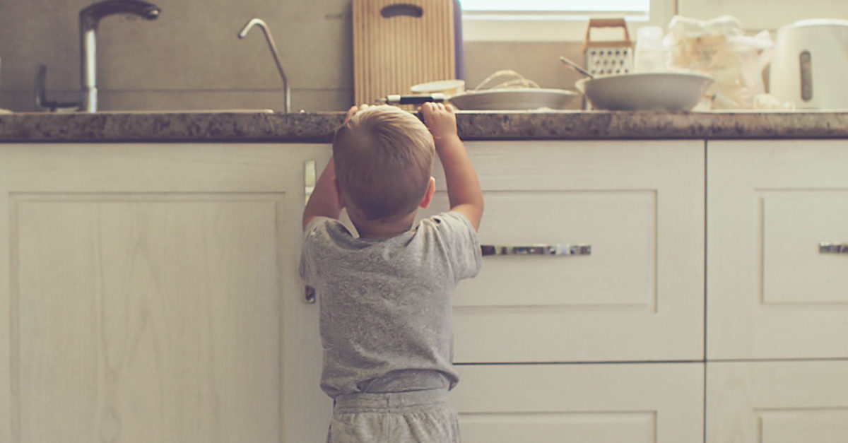 toddler reaching for items on kitchen counter