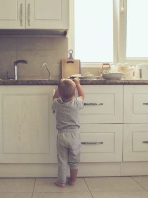 toddler reaching for items on kitchen counter