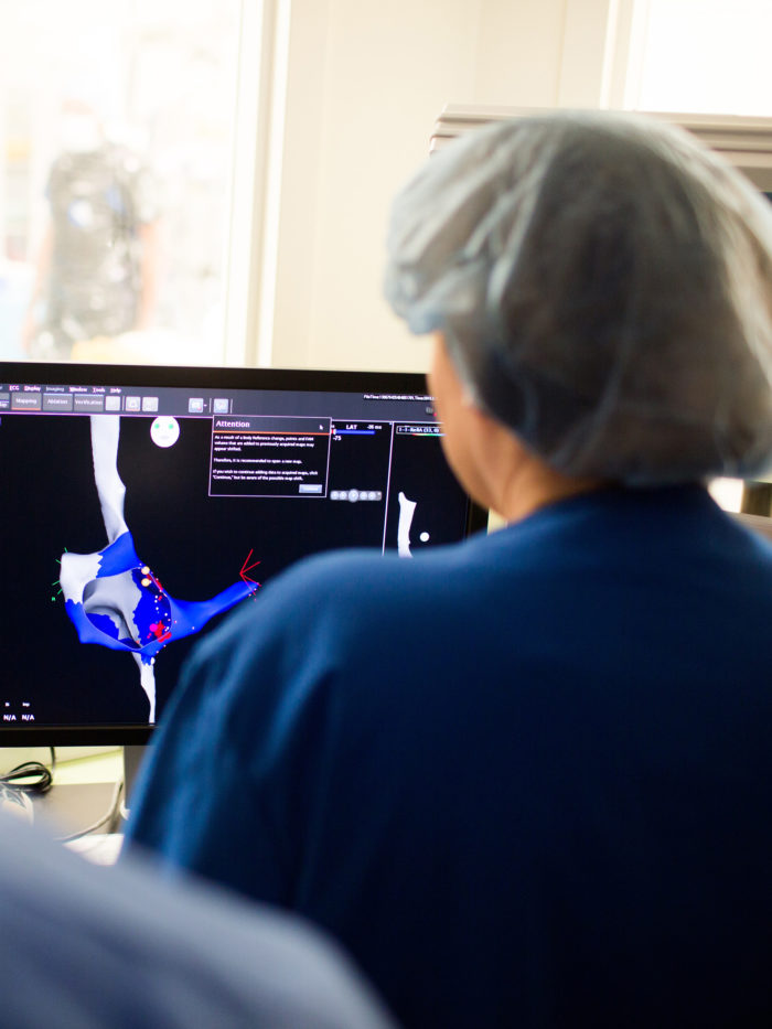 Dr. Michael Recto loking at digital model of patient heart on computer