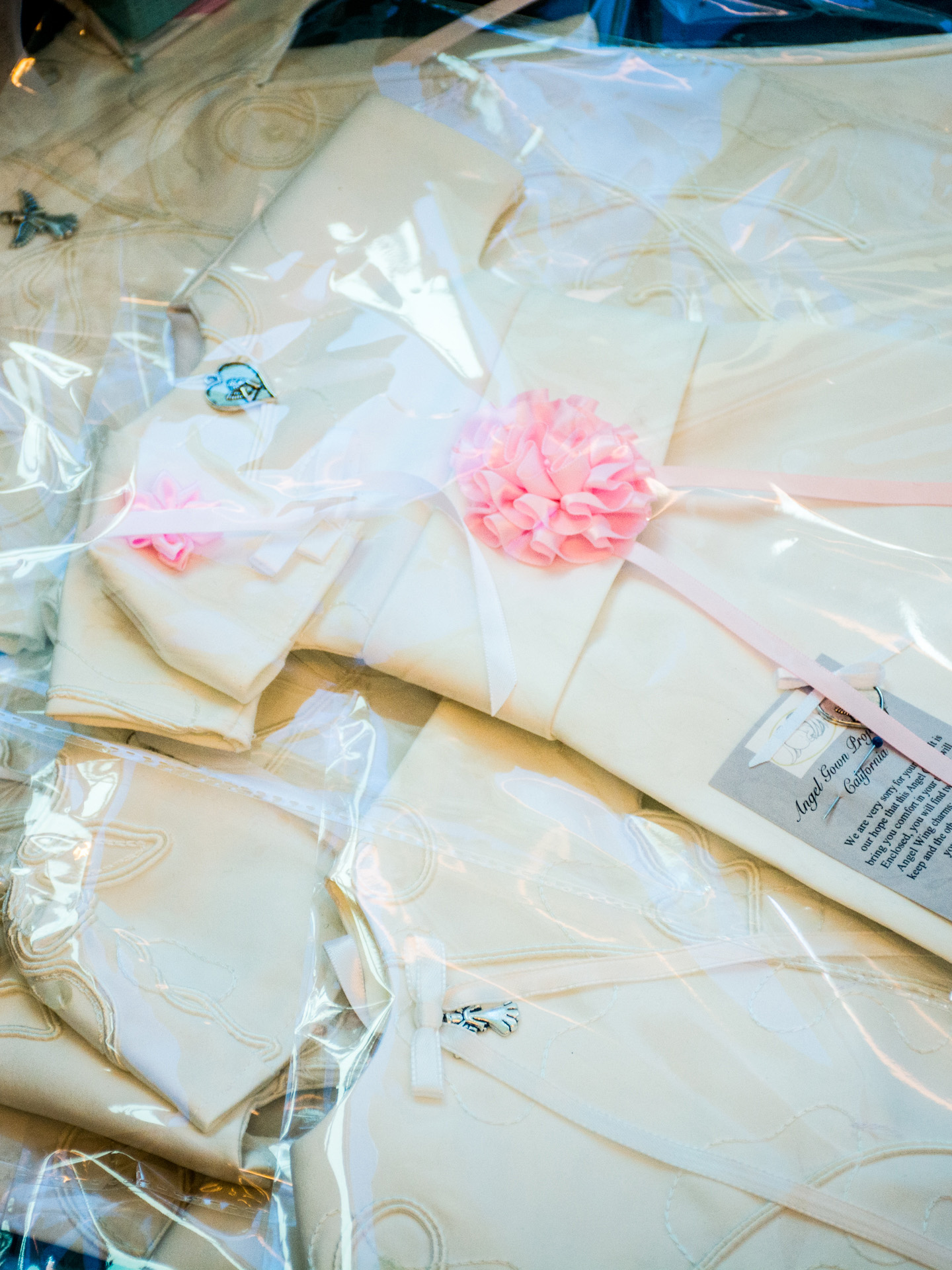 stack of packaged angel gowns made from a wedding dress