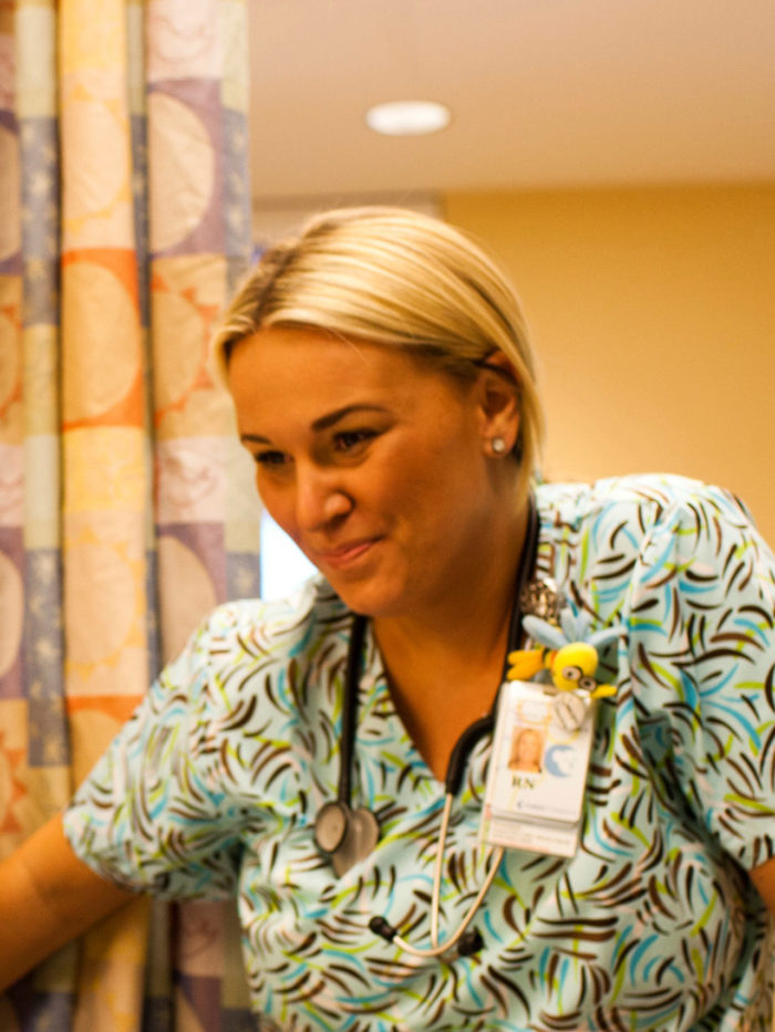 Kim, CHOC oncology nurse, smiling at a patient