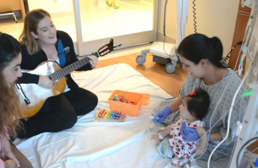 A music therapy session conducted in tandem with occupational therapy in the NICU.