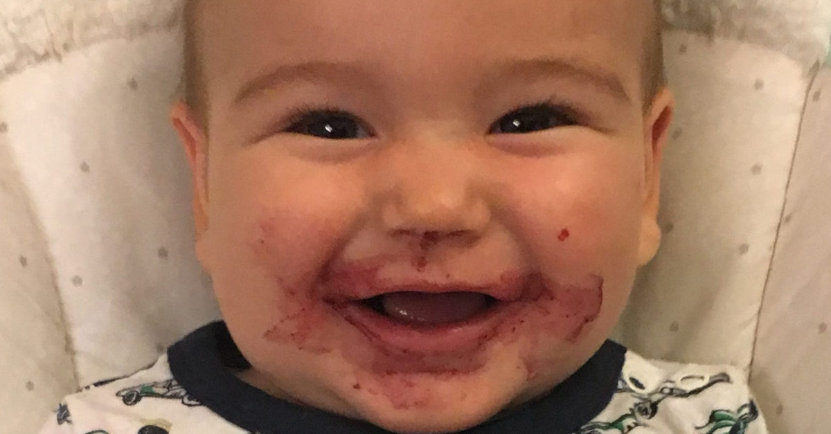 CHOC patient Marco smiling with with food smeared on his face