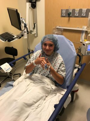 Sarah in a hospital bed for a surgical treatment called endoscopic thoracic sympathectomy, or ETS surgery