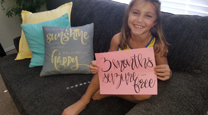 Rylee holding a sign that says "3 months seizure free"