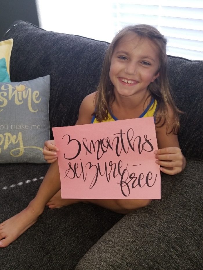 Rylee holding a sign that says "3 months seizure free"