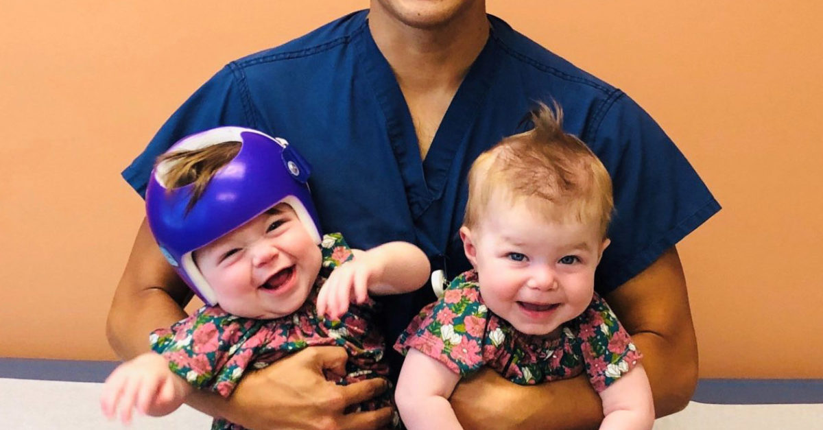 CHOC surgeon Dr. Peter Yu holding twins Bowie and Finley