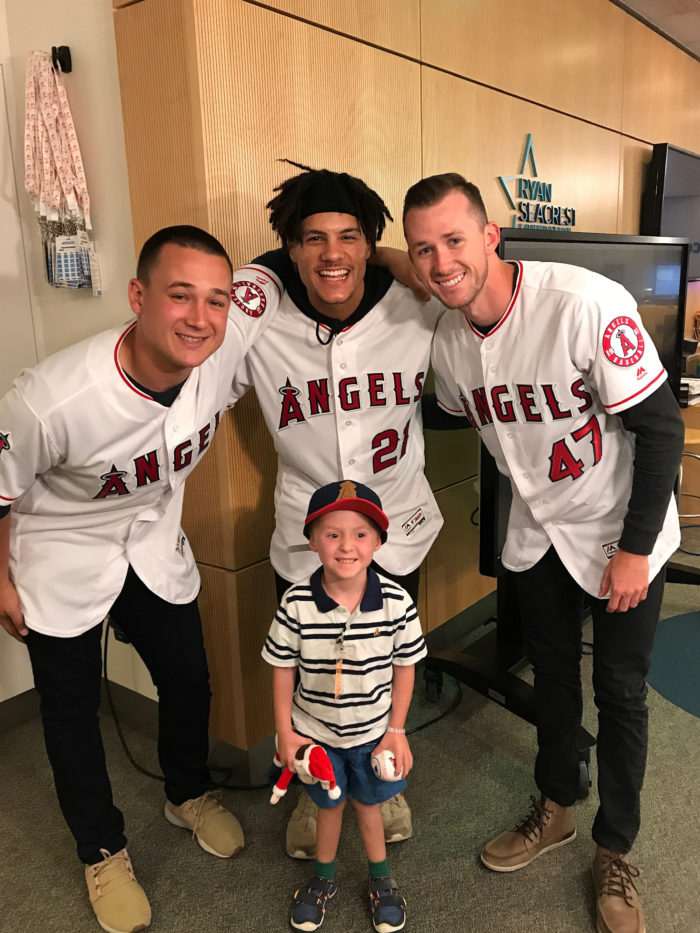 CHOC patient Jack posing with Angels baseball players