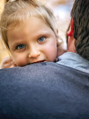 Bud holding his daughter Emma over his shoulder