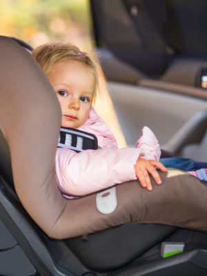 Toddler sitting in forward-facing car seat