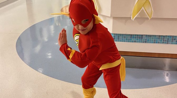 Austin wears a superhero costume at CHOC