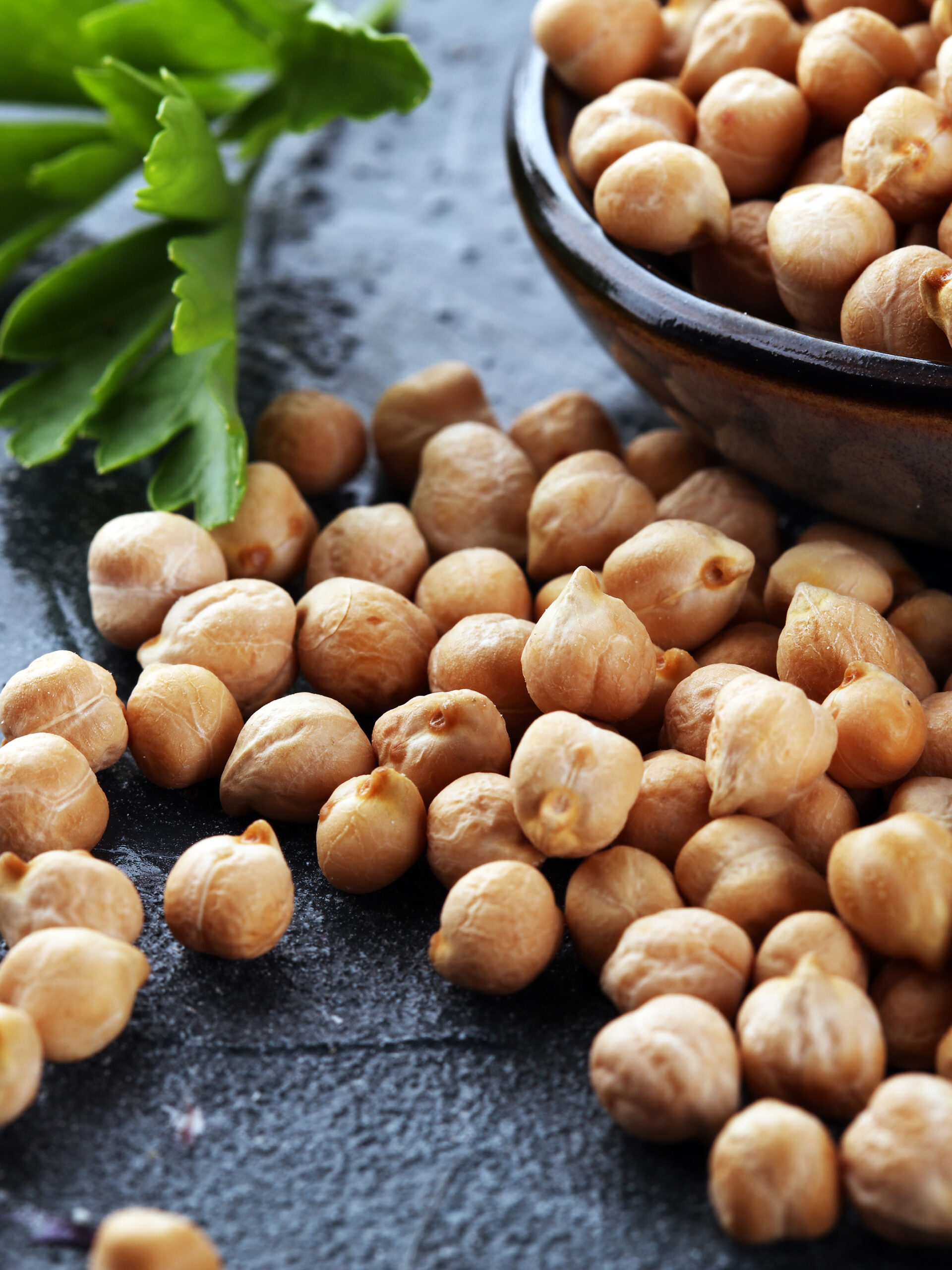 Raw chickpeas on black table - the benefits of adding chickpeas to your child's diet