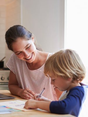 mom and son at home doing homework at kitchen table