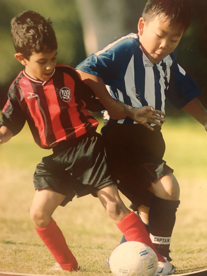 young Eric playing soccer