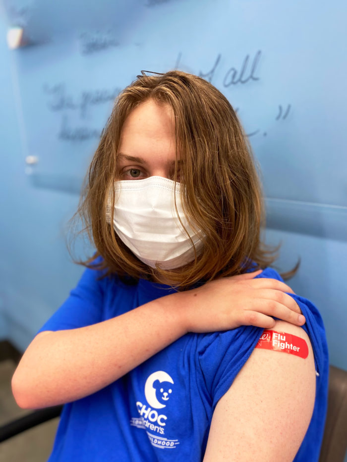 boy with bandaged arm after receiving vaccine