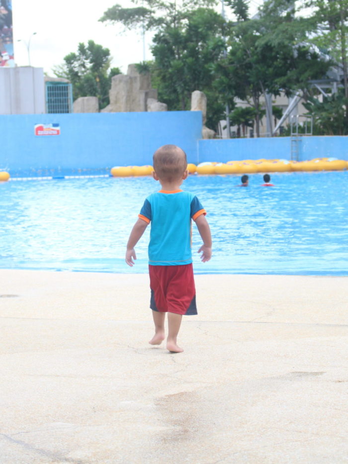 Toddler walking unattended toward pool