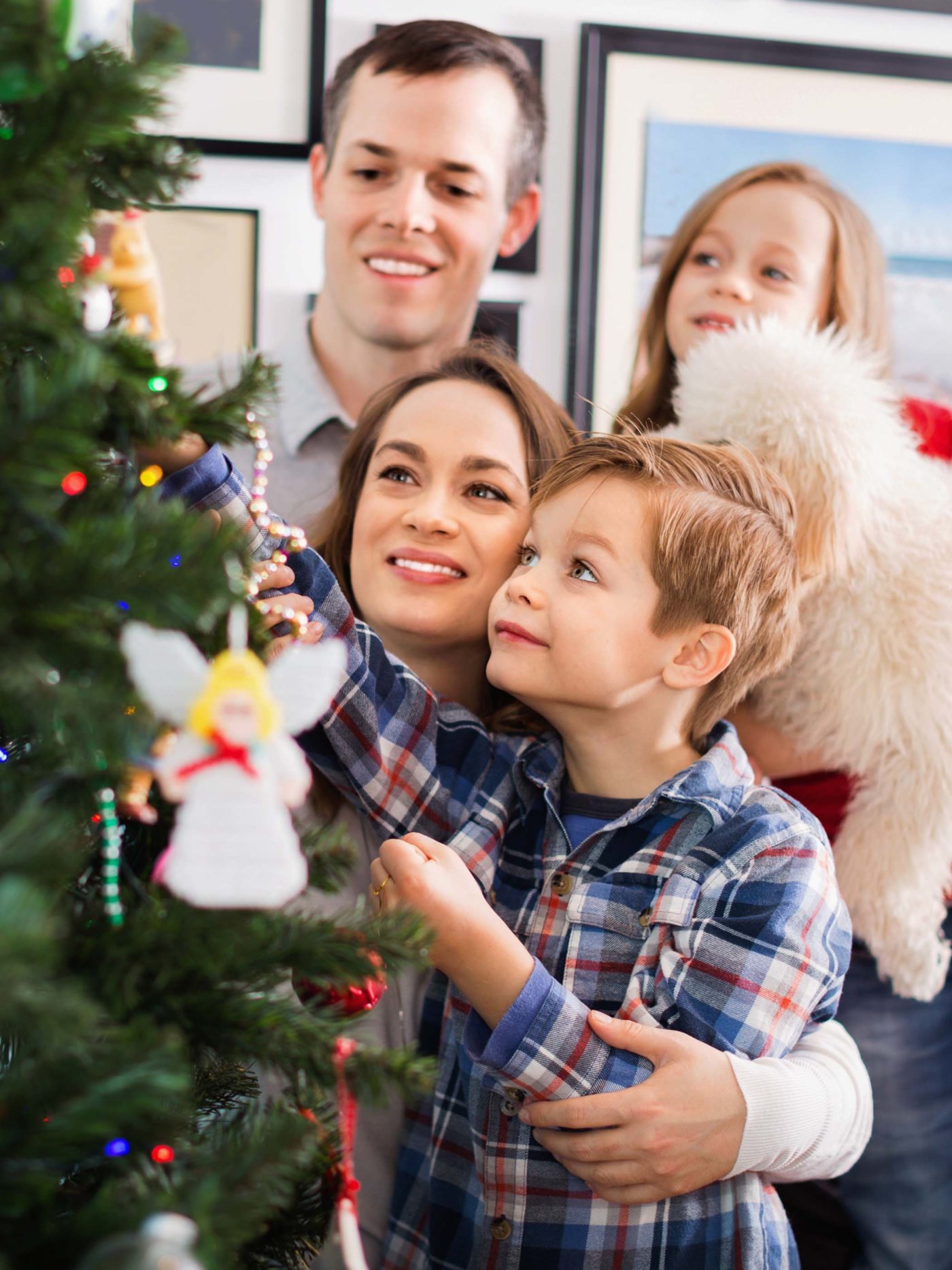 Family decorates their Christmas tree together