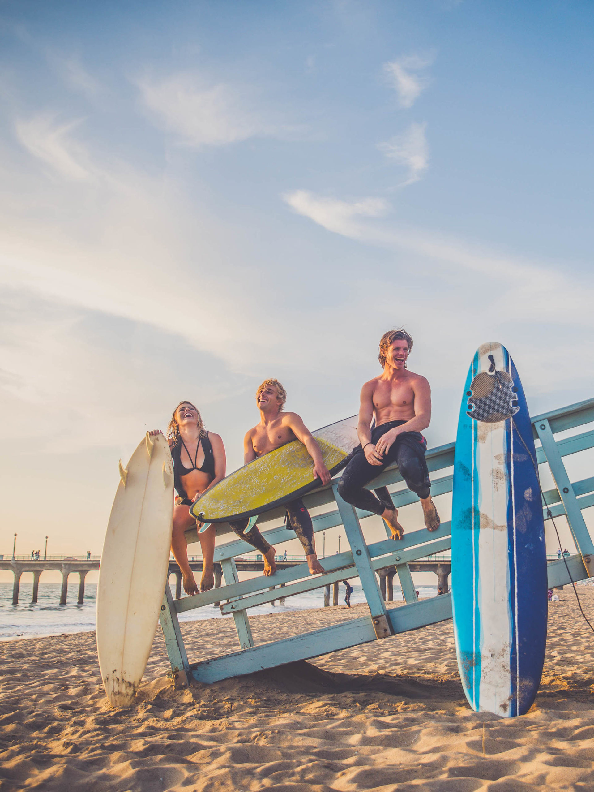 group of teens with surfboards at the beach