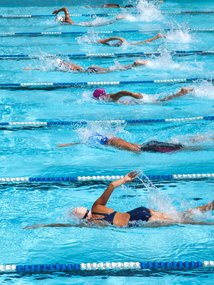 a group of swimmers in a freestyle race