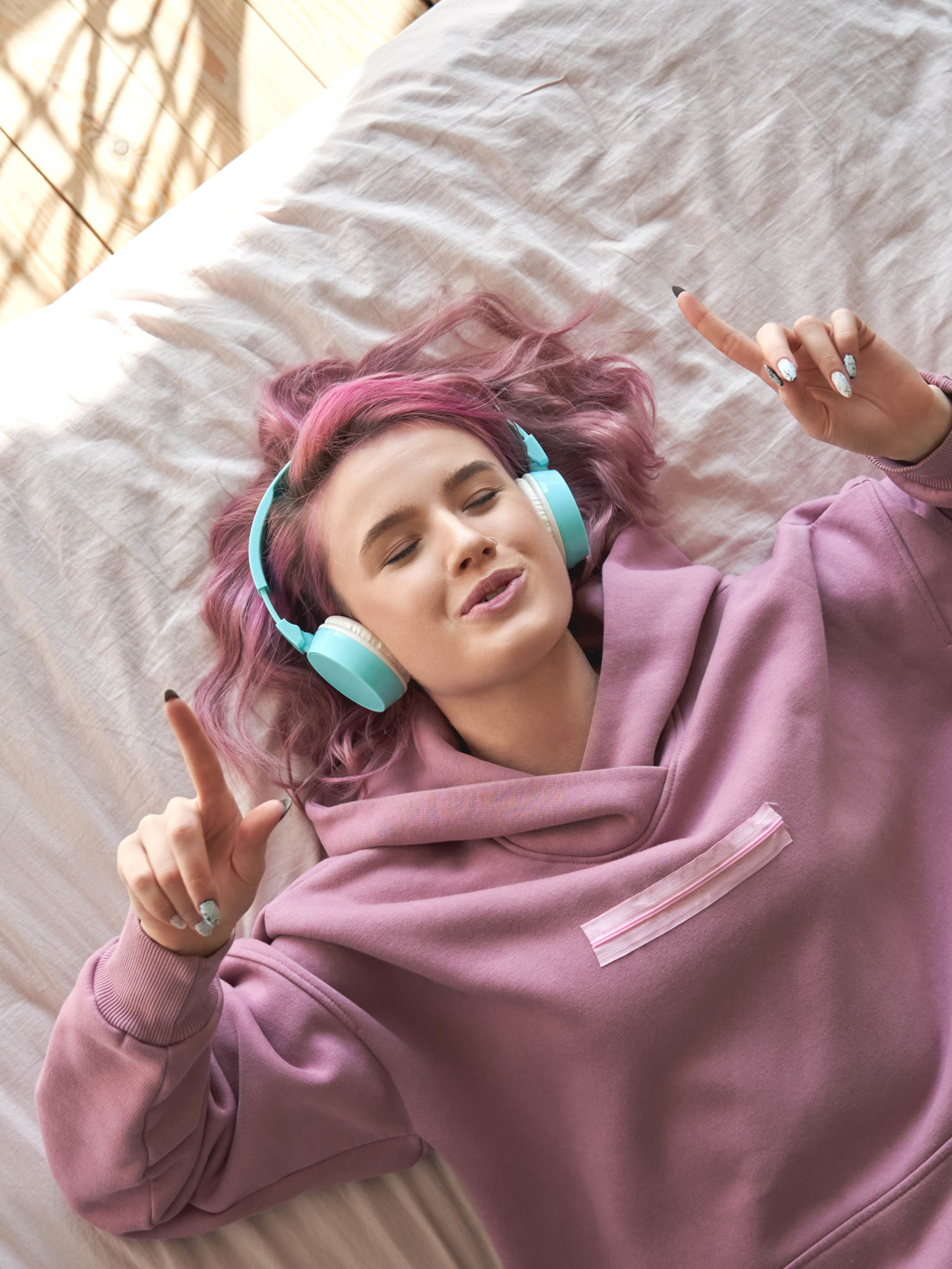 teen girl wearing headphones listening to music singing along