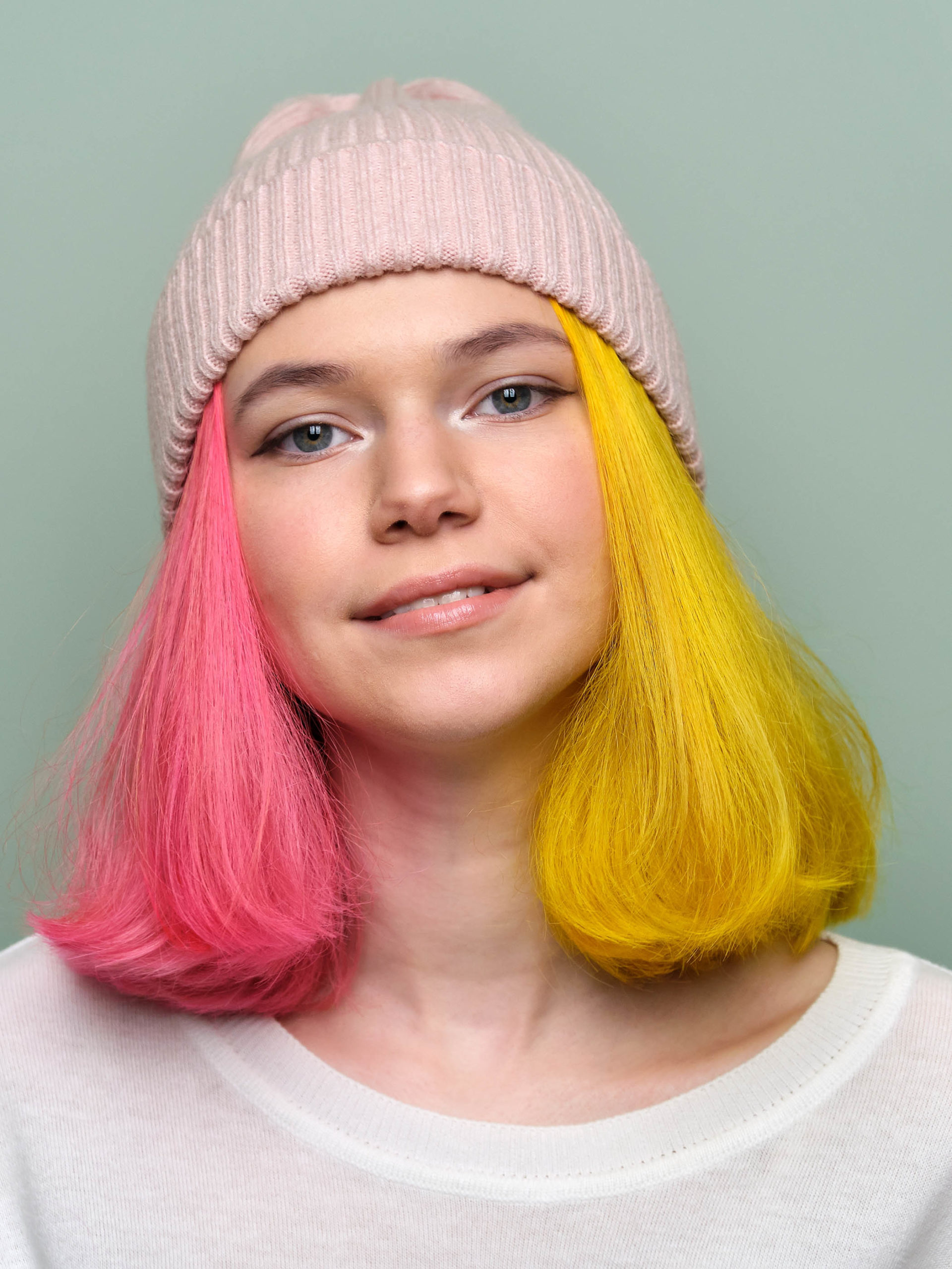trendy teenager girl with colored dyed hair and a beanie