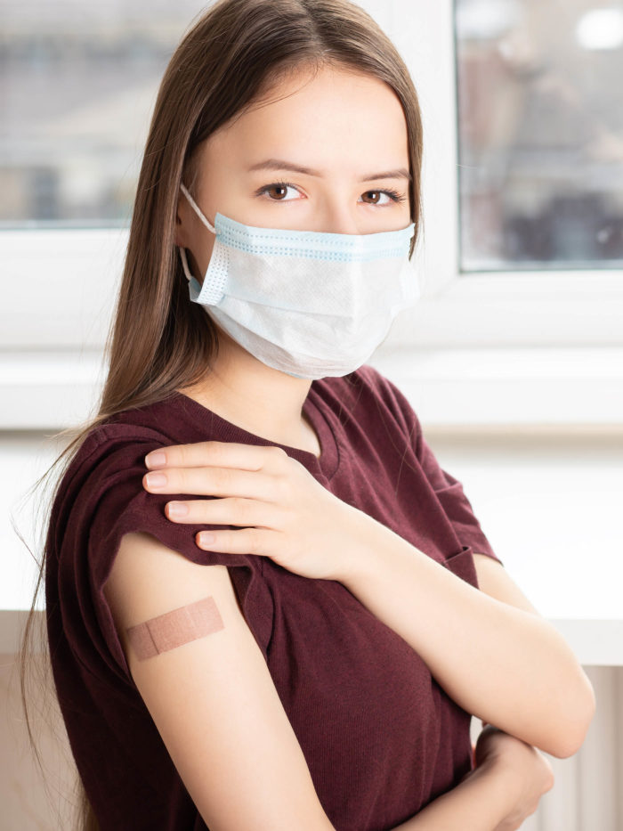 teen girl showing that she just received a vaccine