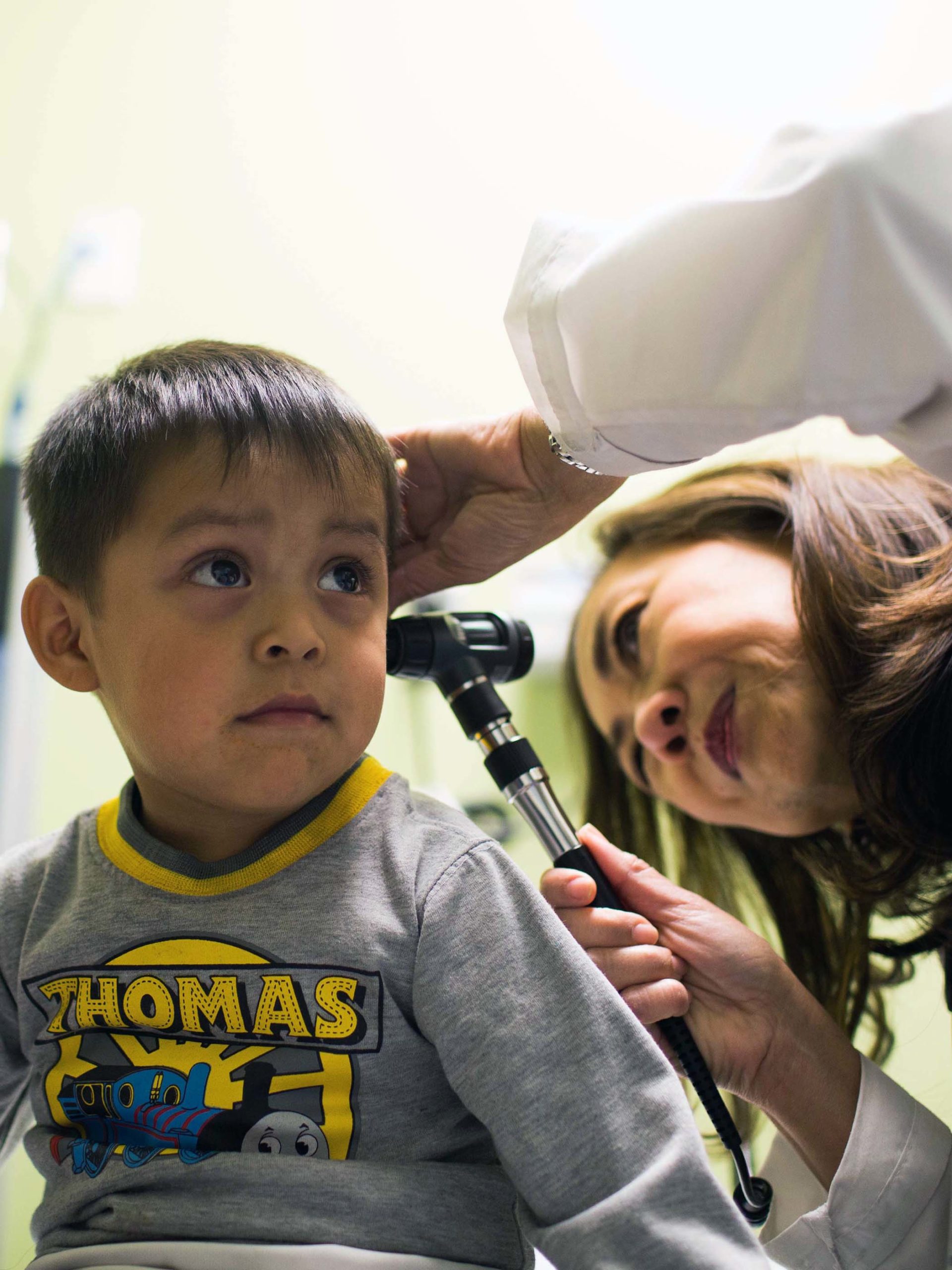 CHOC doctor Dr. Maria Tupas examining patient ear