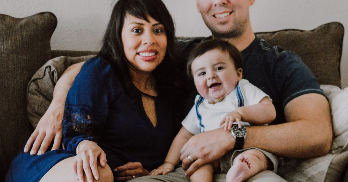 Lizette and her husband Sean posing in a family photo with their son Landon
