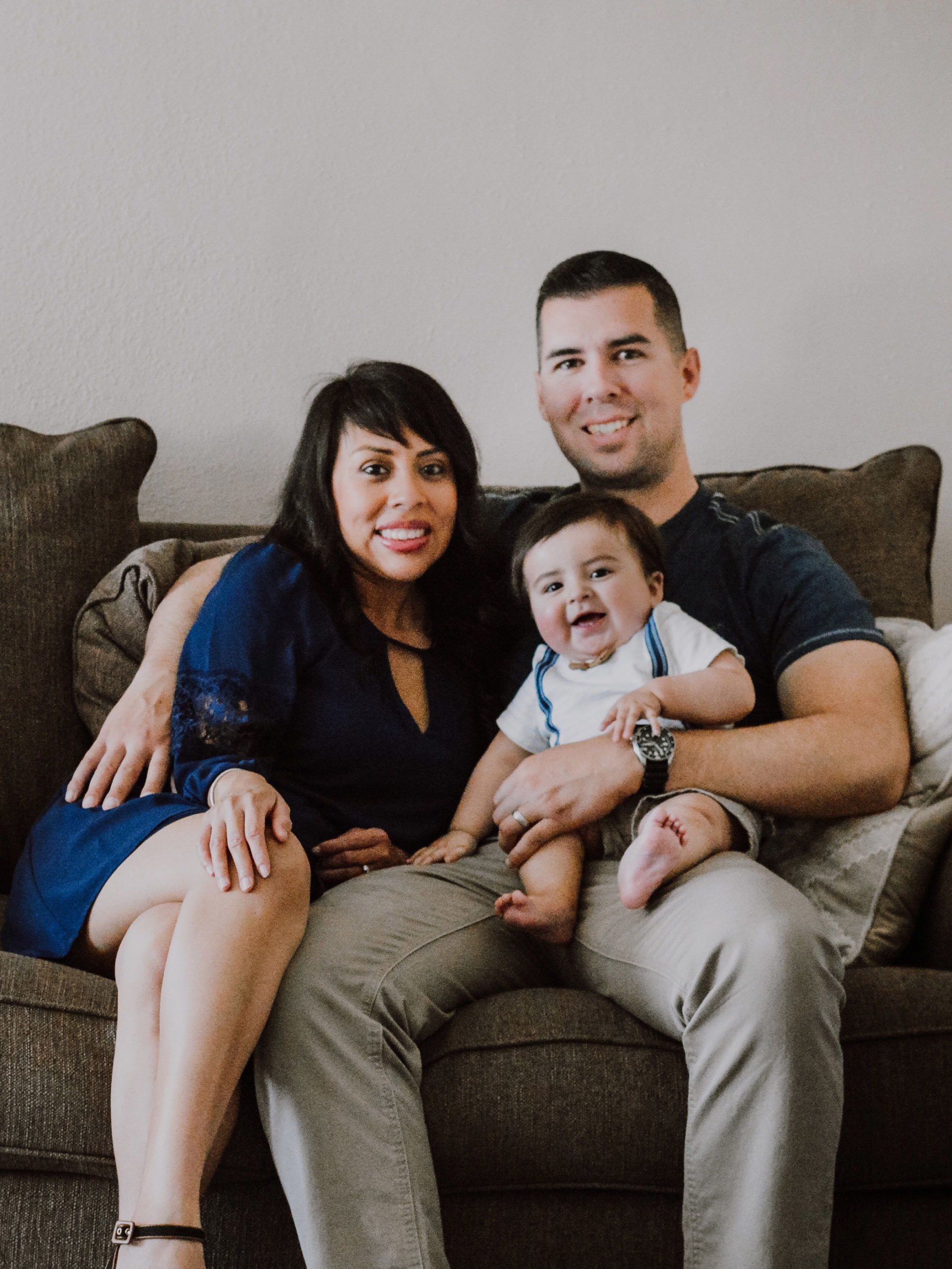 Lizette and her husband Sean posing in a family photo with their son Landon