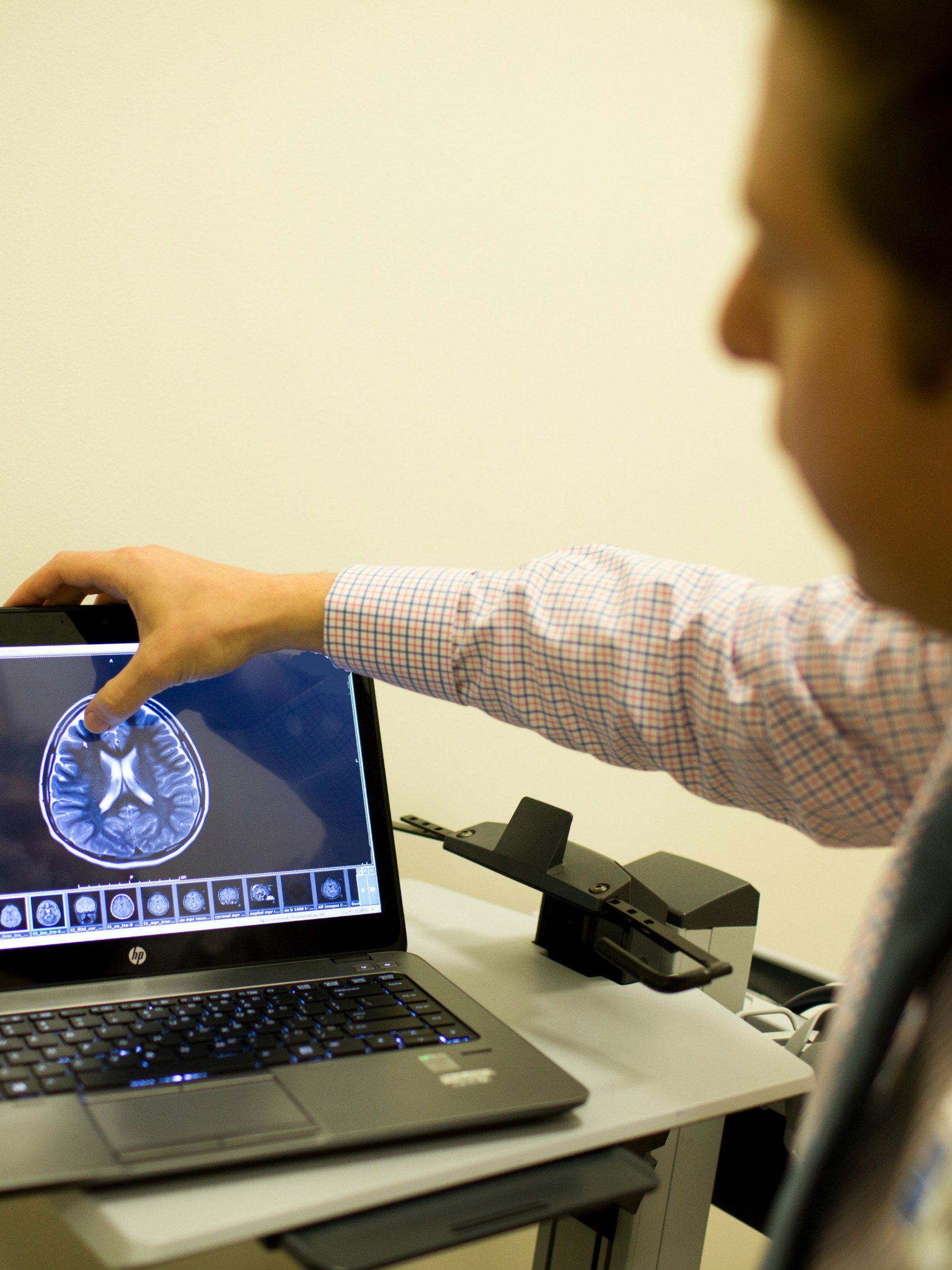 CHOC neurologist Dr. Sharief Taraman looking at brain imaging on laptop