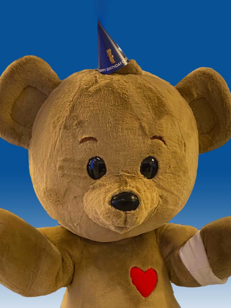 CHOC's Choco bear mascot wearing a party hat