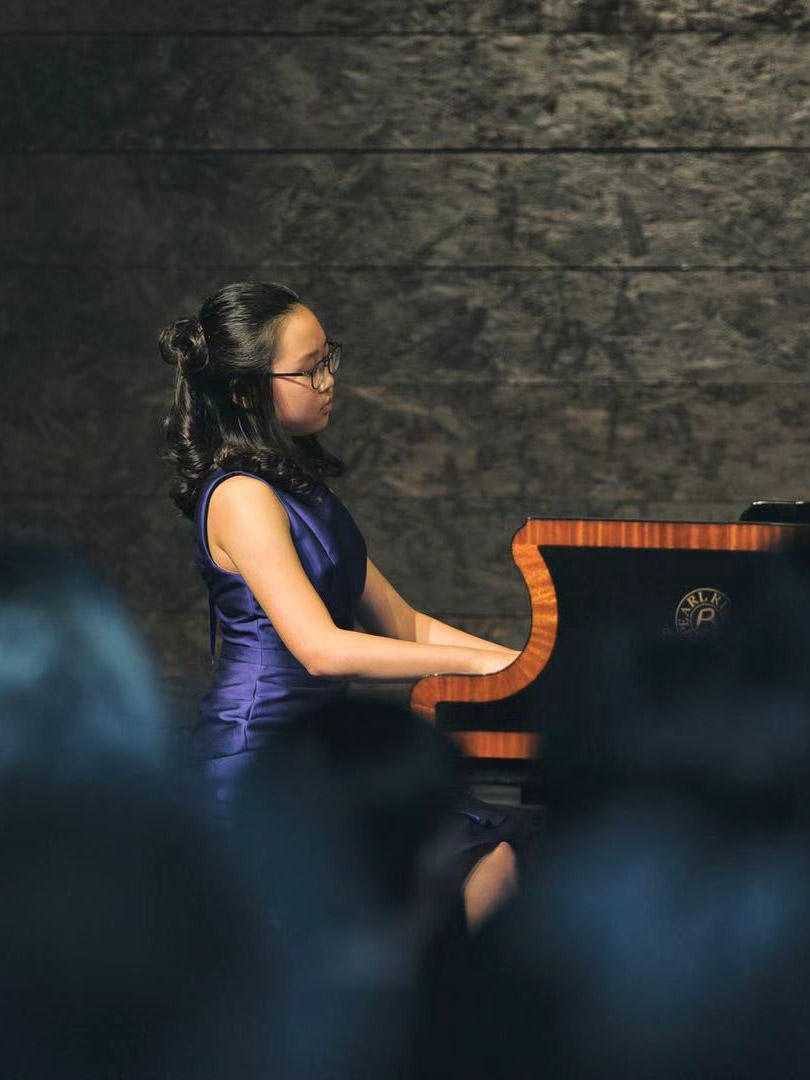 CHOC patient Lucie performing at a piano recital to raise money for CHOC