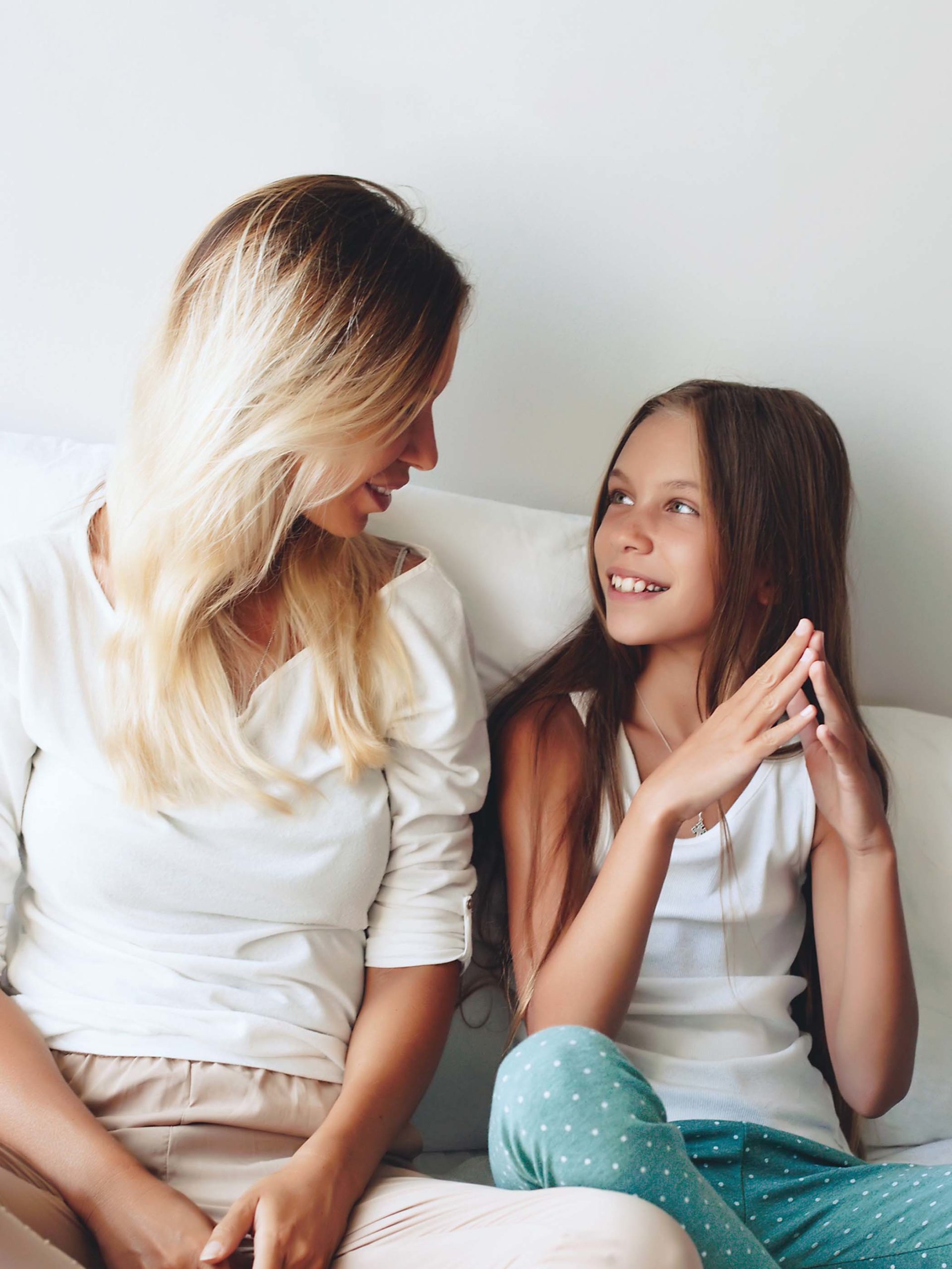 mom and daughter talking and smiling