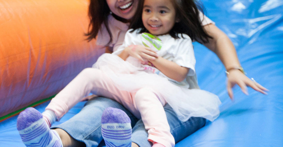 CHOC pediatrician Dr. Herrera sliding down slide with her daughter