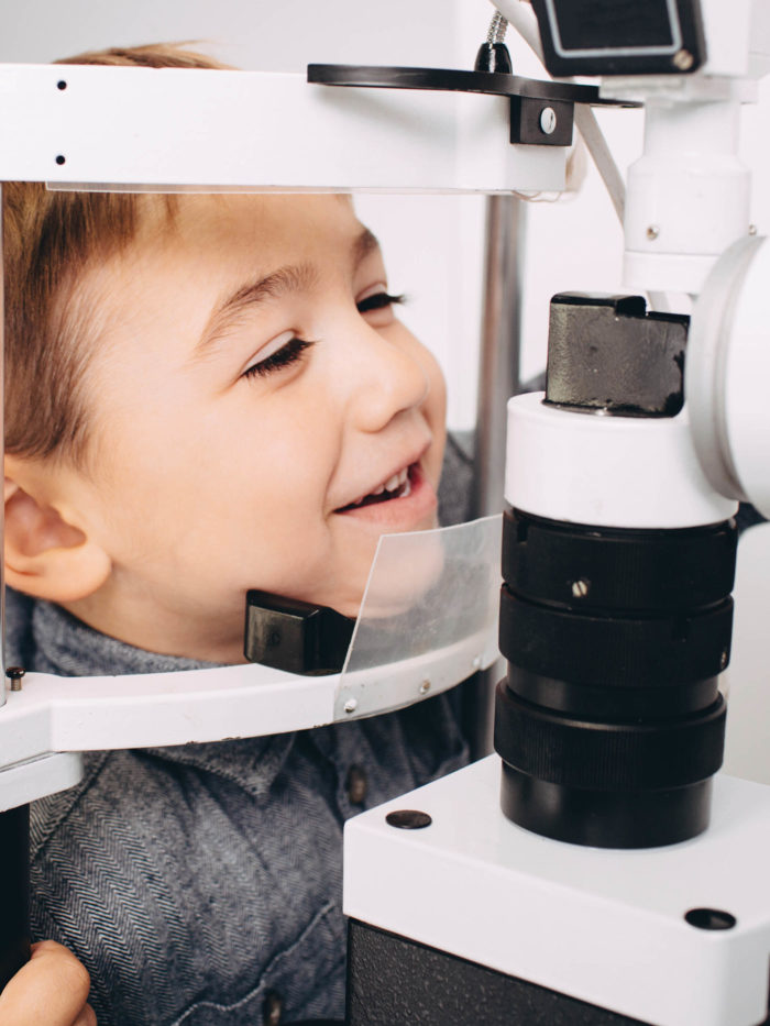 Happyboy receiving eye exam at clinic