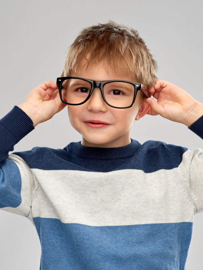 smiling little boy wearing thick glasses