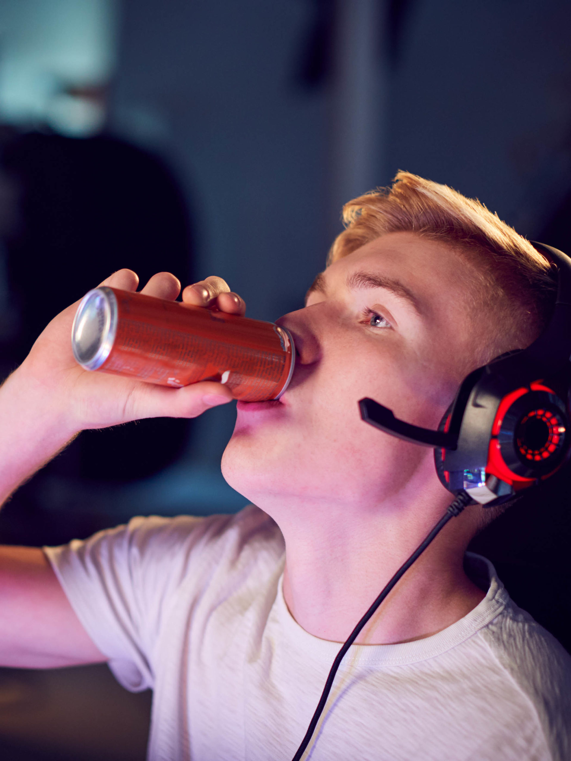 Teenage Boy Drinking Caffeine Energy Drink while Gaming
