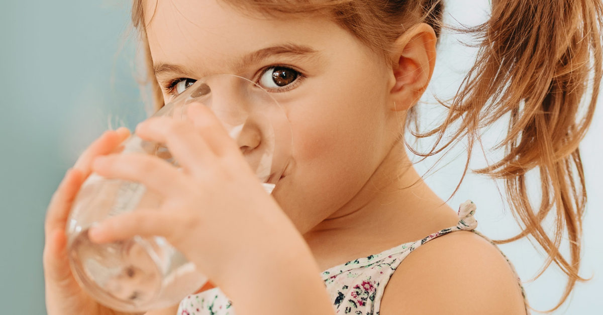 girl drinking clean fresh water from a glass