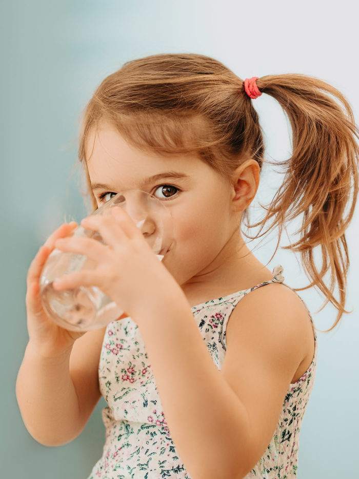 girl drinking clean fresh water from a glass