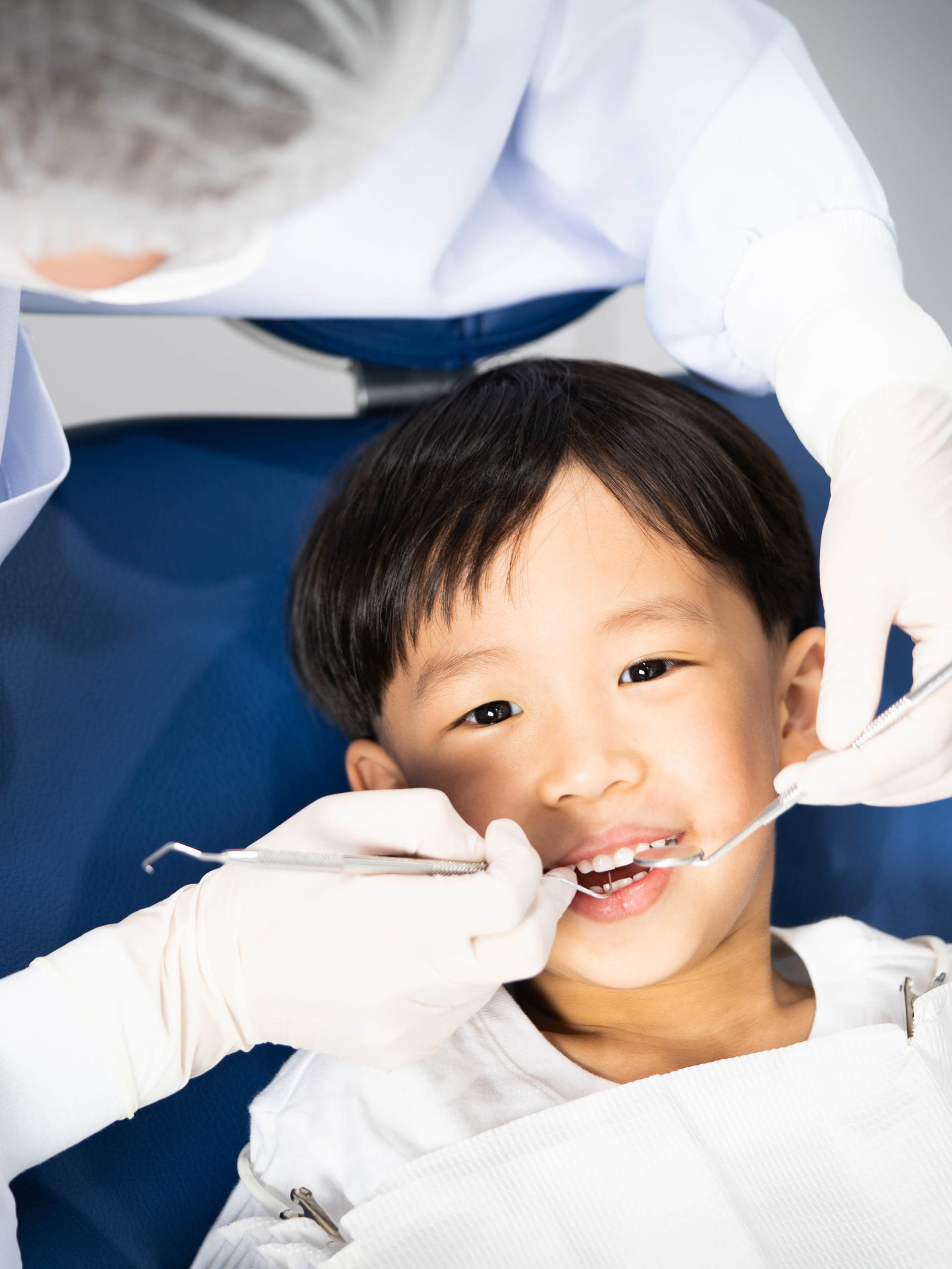 young boy having teeth examined at dentist